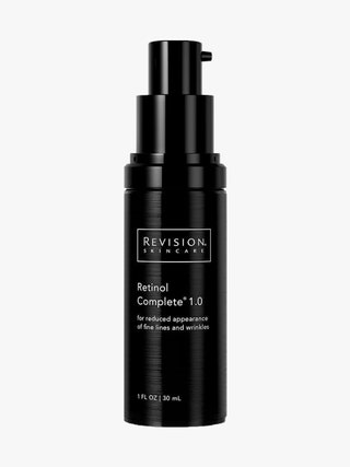 Revision Skincare Retinol Complete 1.0 black pump bottle on light gray background