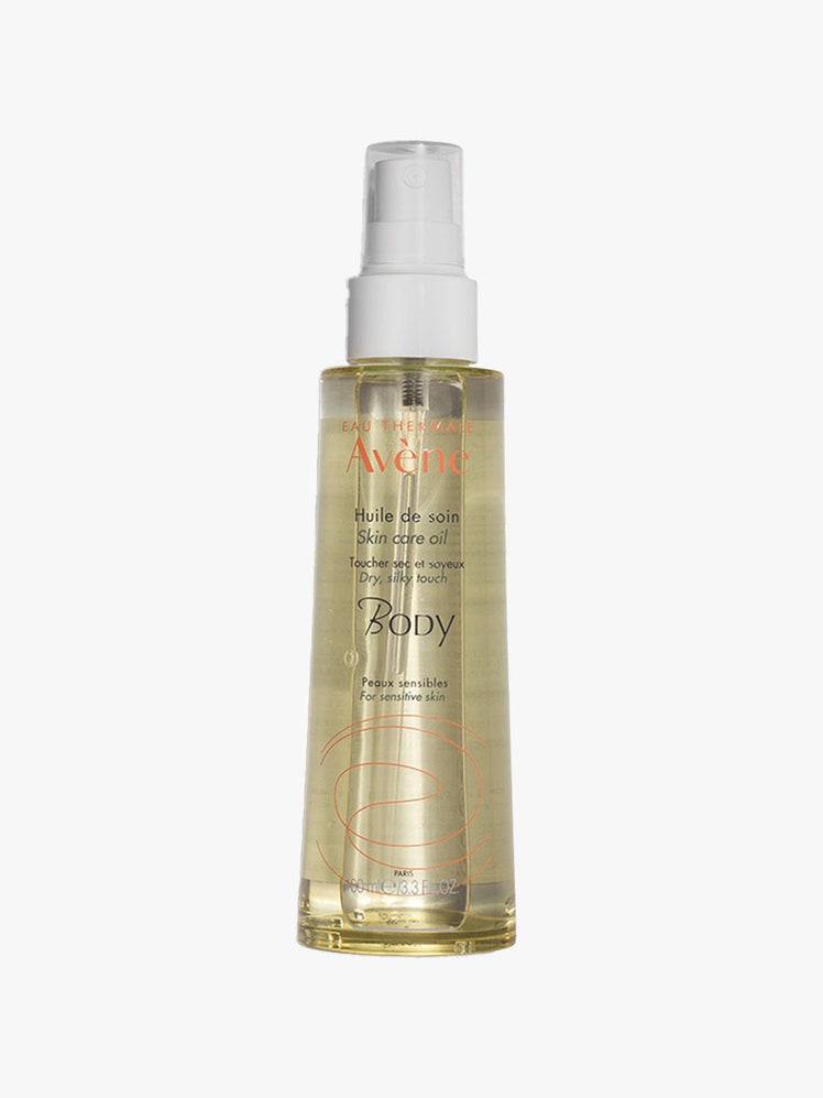 Eau Thermale Avène Body Oil spray bottle on a light gray background