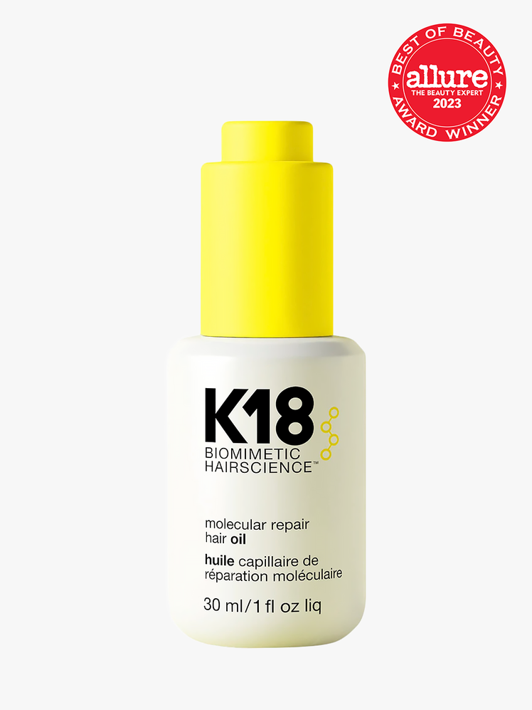K18 Molecular Repair Hair Oil in branded white bottle with neon yellow pump on light gray background
