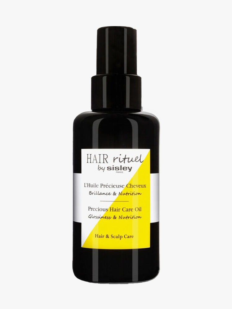 Sisley Paris Hair Rituel Precious Hair Care Oil black bottle with white and yellow label on light gray background