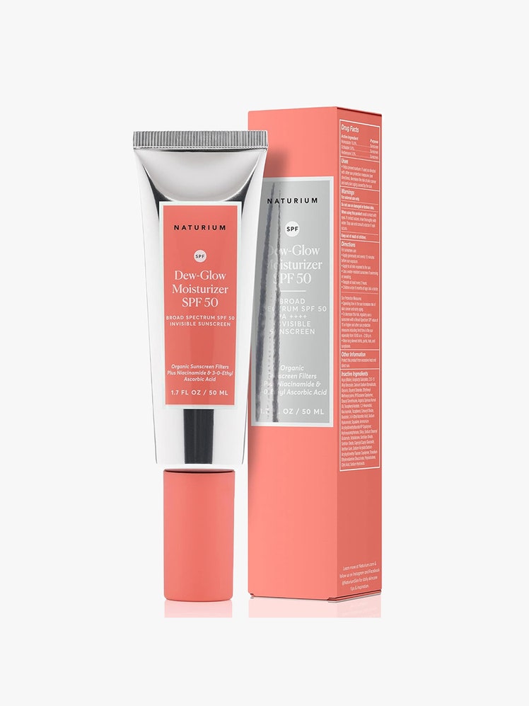 Naturium Dew-Glow Moisturizer SPF 50: A silver and peach-colored tube of sunscreen alongside its matching packaging box on a light gray background