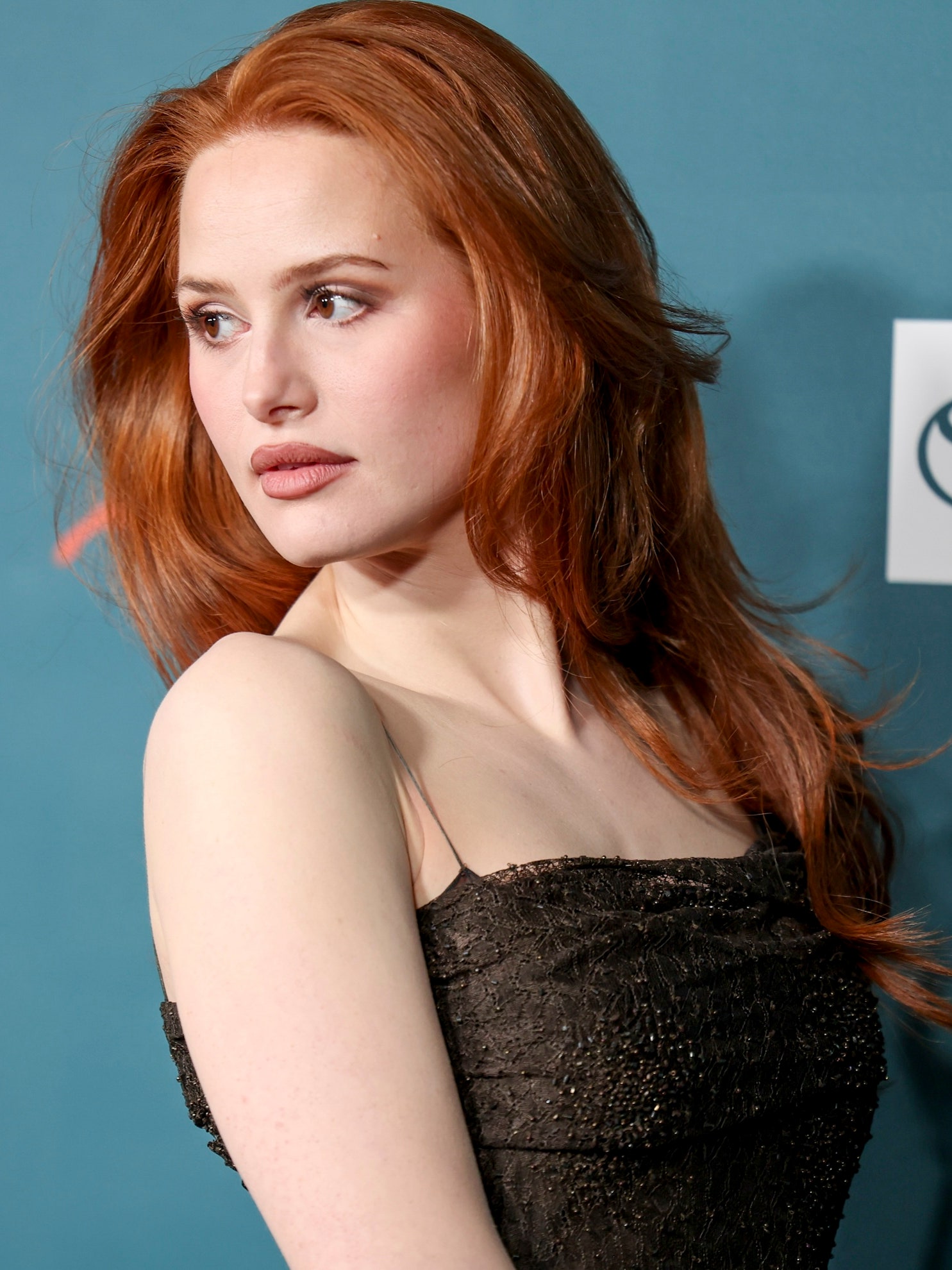 Madelaine Petsch with long layers and fiery red hair color trend