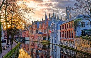 buildings reflected in water at dusk