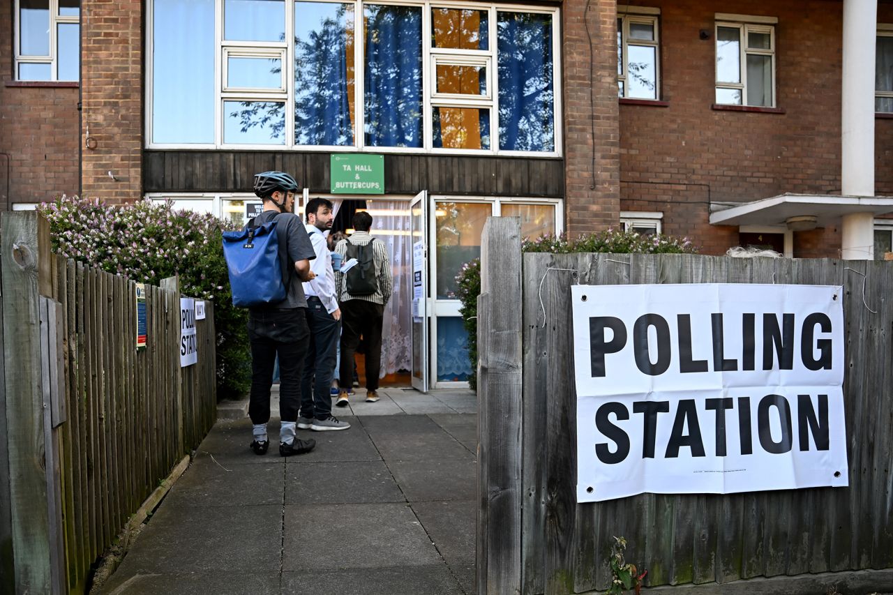 People queue to vote at a polling station in London, England, on July 4.