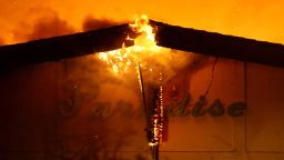 PARADISE, CA - NOVEMBER 08:  A sign is posted on the Paradise Skilled Nursing center as it is consumed by flames from the Camp Fire on November 8, 2018 in Paradise, California. Fueled by high winds and low humidity, the rapidly spreading wildfire has ripped through the town of Paradise, charring 18,000 acres and destroying dozens of homes in a matter of hours. The fire is currently at zero containment. (Photo by Justin Sullivan/Getty Images)