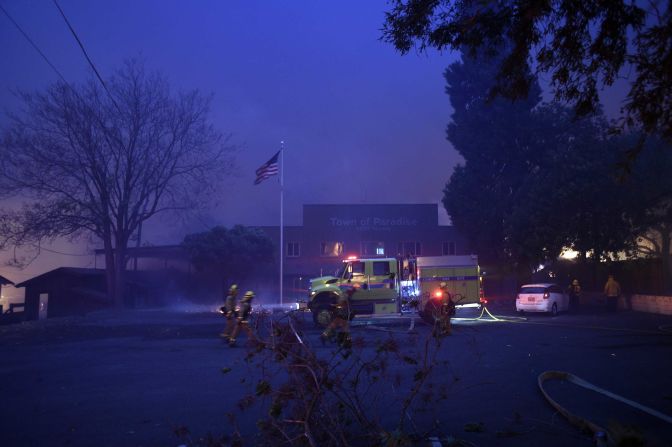 A fire emergency crew works to protect the Paradise Town Hall from the encroaching Camp Fire on November 8.