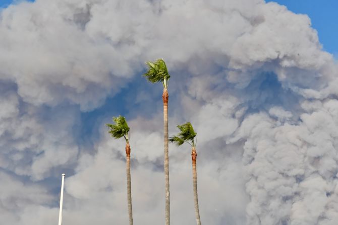 Smoke billows above Malibu trees in this photo <a href="https://www.instagram.com/p/Bp92n5LnoB1/" target="_blank" target="_blank">posted to Instagram</a> by Julie Ellerton.