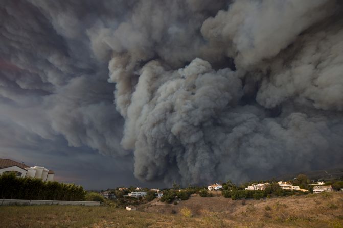 A massive smoke plume, powered by strong winds, rises above the Woolsey Fire in Malibu on November 9.