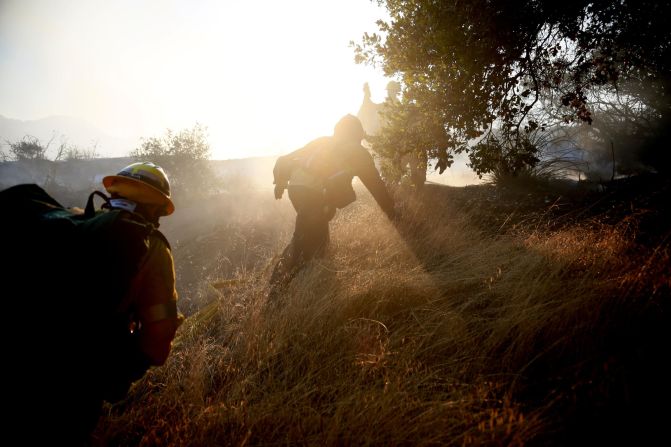 Firefighters battle a blaze in Malibu on Saturday, November 10.