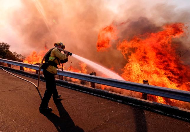 A firefighter battles a fire in Simi Valley on November 12.