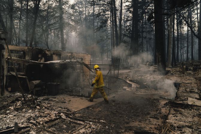 Firefighters put out hot spots in Paradise on November 12.