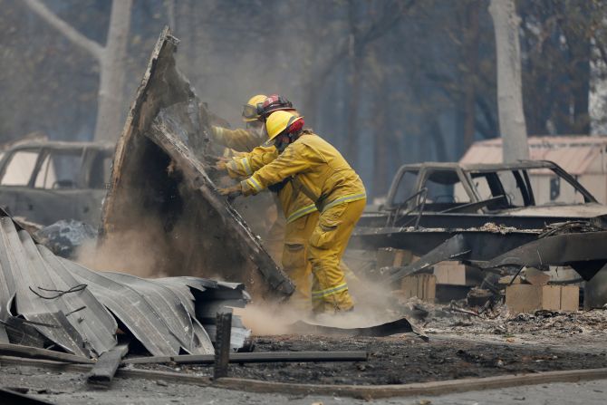 Firefighters search through the remains of a Paradise house on November 13.