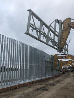 Dozens of men work between 7 a.m. and 9 p.m. daily to finish the three-mile stretch of private wall.