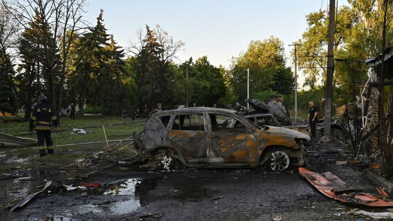 Firefighters and police officers work at a site of a Russian missile strike in the town of Vilniansk, in the Zaporizhzhia region.