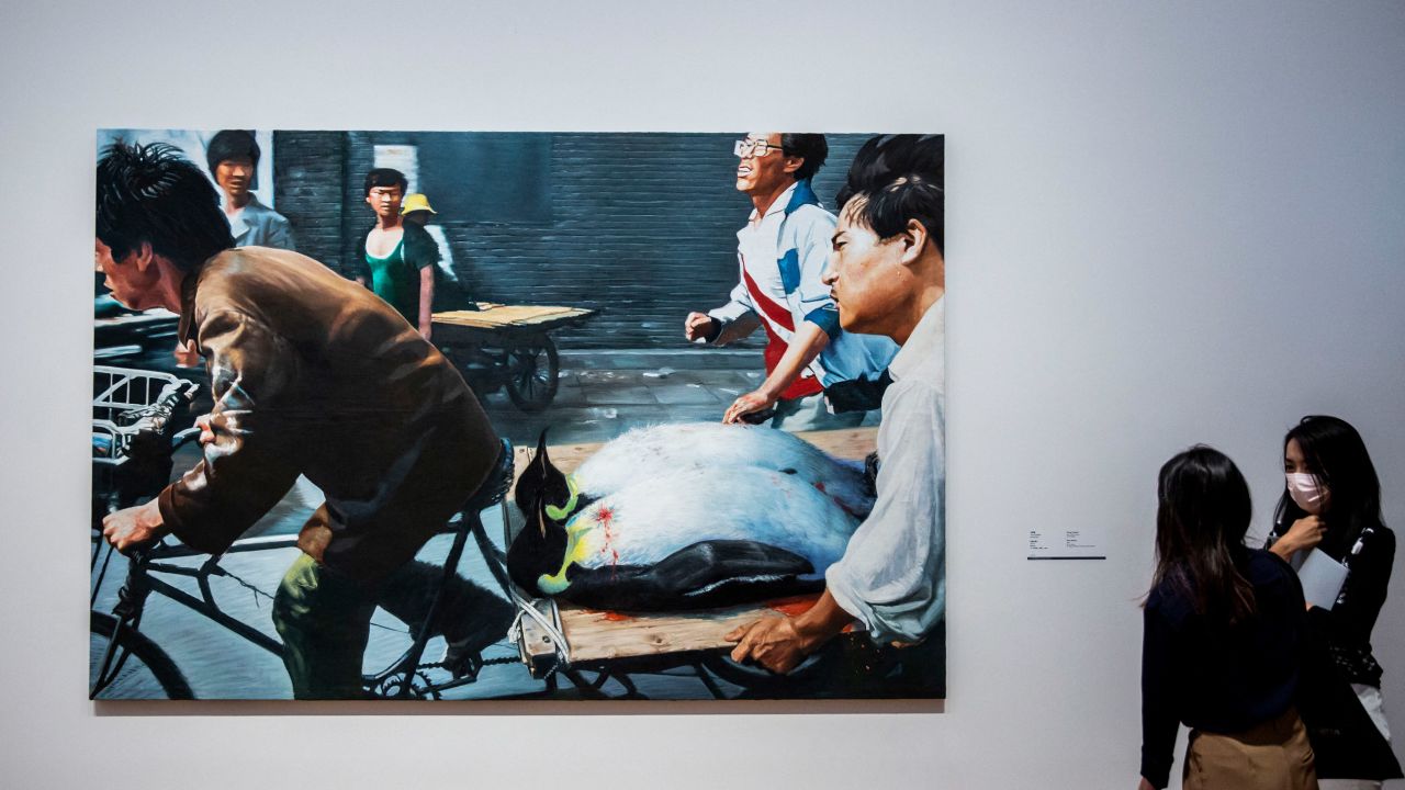 Members of the media look at New Beijing (2001) by Wang Xingwei during a press tour of the new M+ Museum in Hong Kong on November 11, 2021.