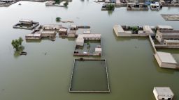 Homes are surrounded by floodwaters in Jaffarabad, a district of Pakistan's southwestern Baluchistan province, Thursday, Sept. 1, 2022. Pakistani health officials on Thursday reported an outbreak of waterborne diseases in areas hit by recent record-breaking flooding, as authorities stepped up efforts to ensure the provision of clean drinking water to hundreds of thousands of people who lost their homes in the disaster. (AP Photo/Zahid Hussain)