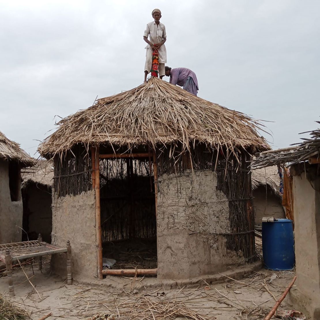 Villagers use materials like mud to fortify the walls of the bamboo shelter. 