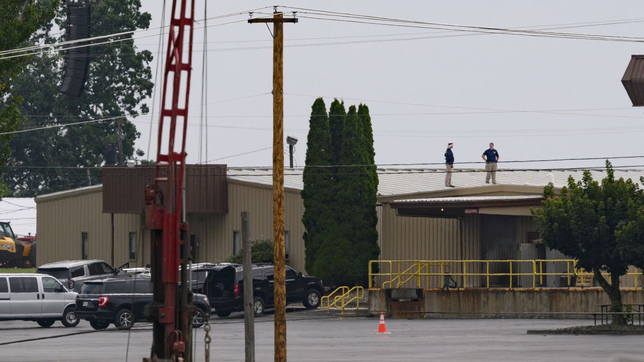 FBI investigators work at the scene of the attempted assassination of former President Donald Trump in Butler, Pennsylvania, the day after shots were fired during a campaign rally.