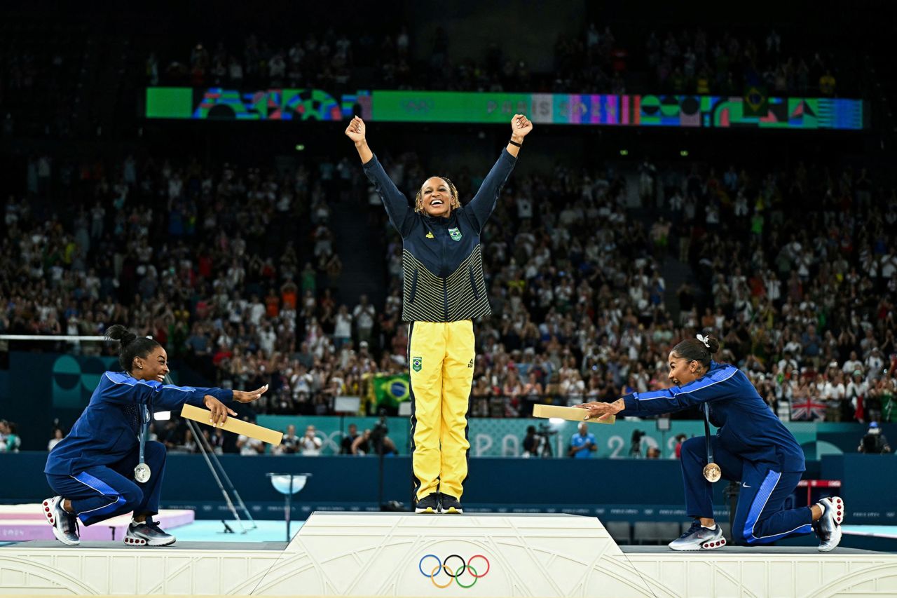 American gymnasts Simone Biles, left, and Jordan Chiles bow to Brazil's Rebeca Andrade after she won Olympic gold in the floor exercise on August 5. It was the first all-Black Olympic gymnastics podium. However, on August 11, the International Olympic Committee announced that Chiles' bronze medal would be reallocated to Romanian gymnast Ana Bărbosu after the Court of Arbitration for Sport ruled that an appeal made by the United States over Chiles' score was filed too late. 