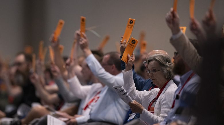 Messengers raise their ballots in support of a motion put up for vote during a Southern Baptist Convention annual meeting Tuesday, June 11, 2024, in Indianapolis. (AP Photo/Doug McSchooler)