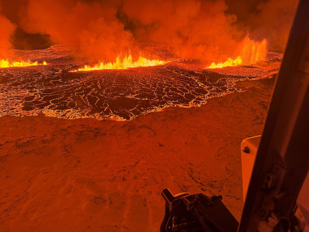 A volcano spews lava and smoke as it erupts north of Grindavik, Iceland, on Tuesday.