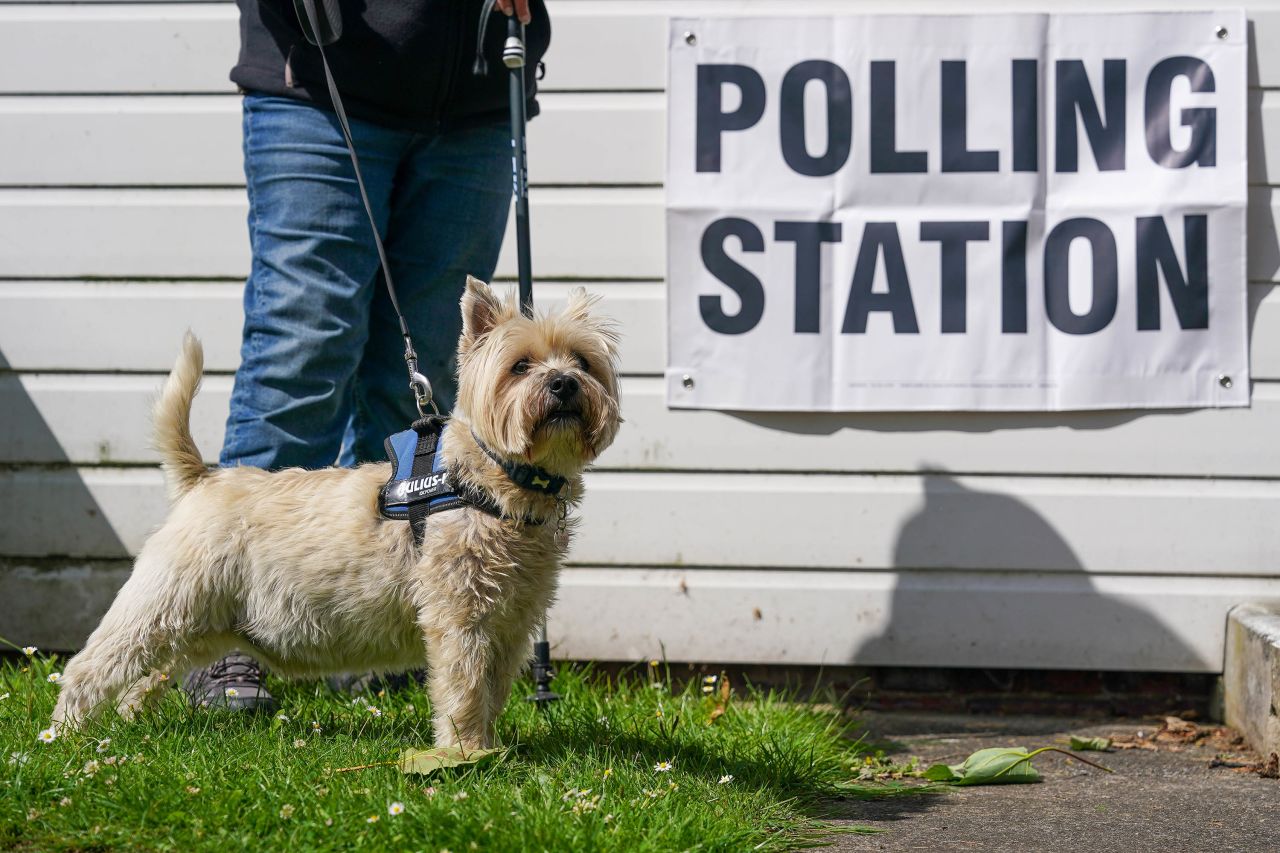 A dog waits outside a polling station in Great Ayton, England.