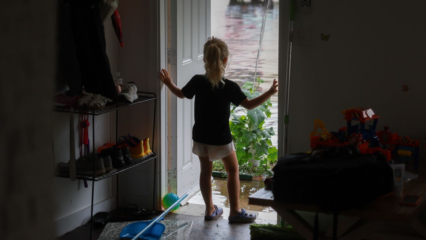 Vera Kalnichenko looks out at the flood waters from her parents' friend's home in Hallandale Beach, Florida, after flood water inundated it on Thursday.