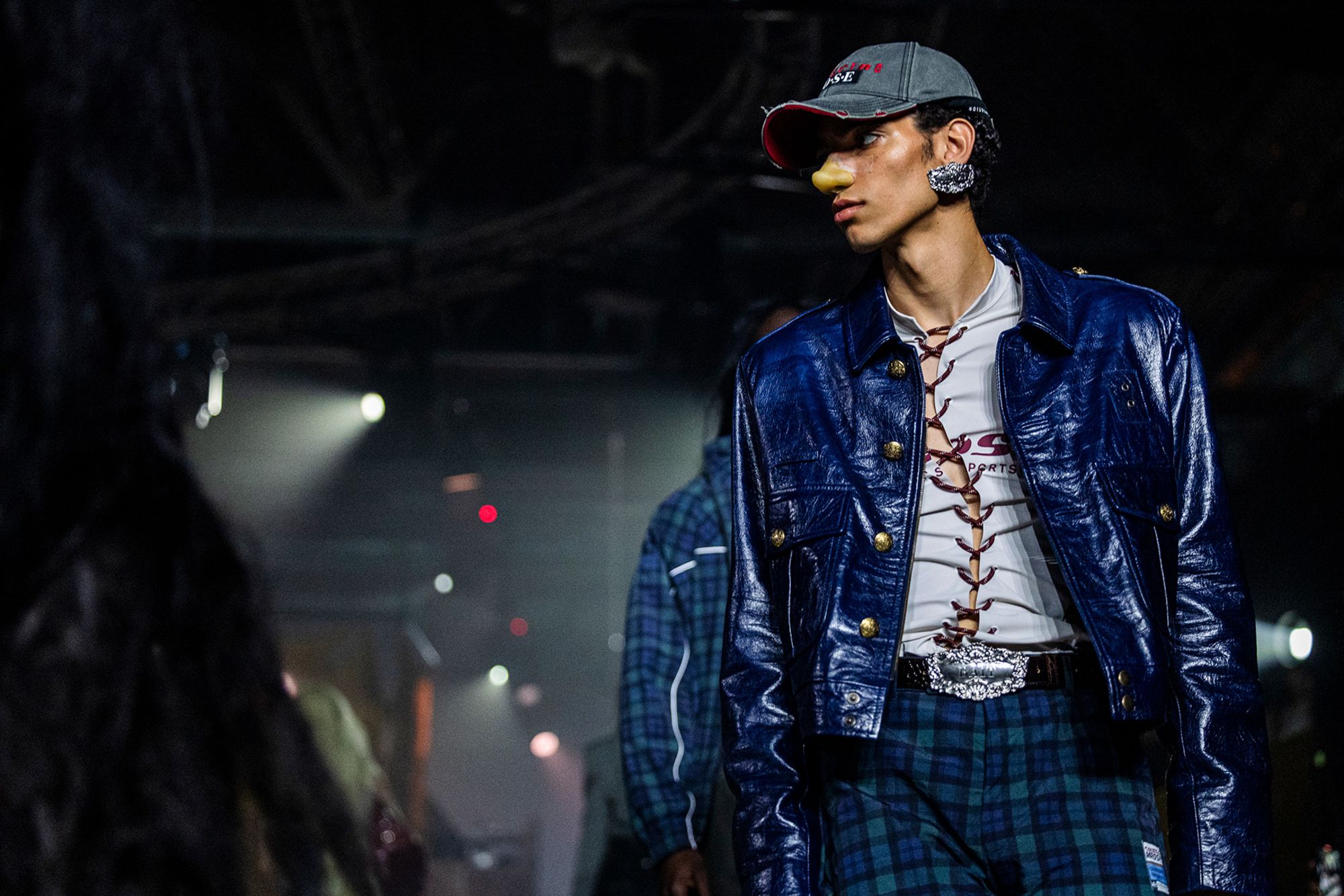 Models walk the runway for Martine Rose's Milan Fashion Week show with prosthetic noses.