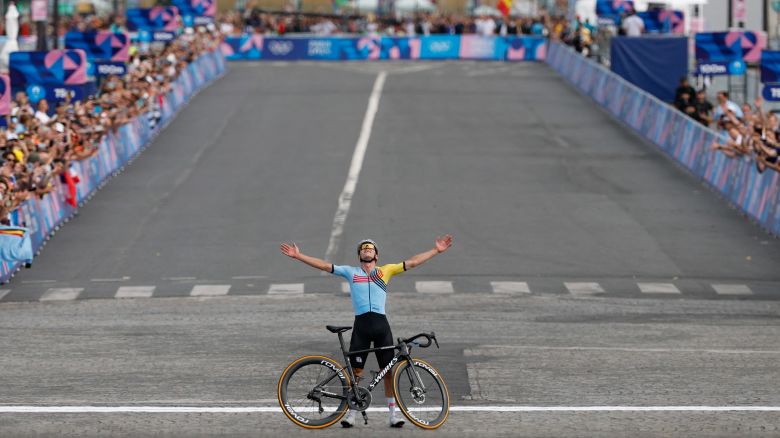 Belgium's Remco Evenepoel celebrates after crossing the finish line to win the men's cycling road race during the Paris 2024 Olympic Games in Paris, on August 3, 2024.