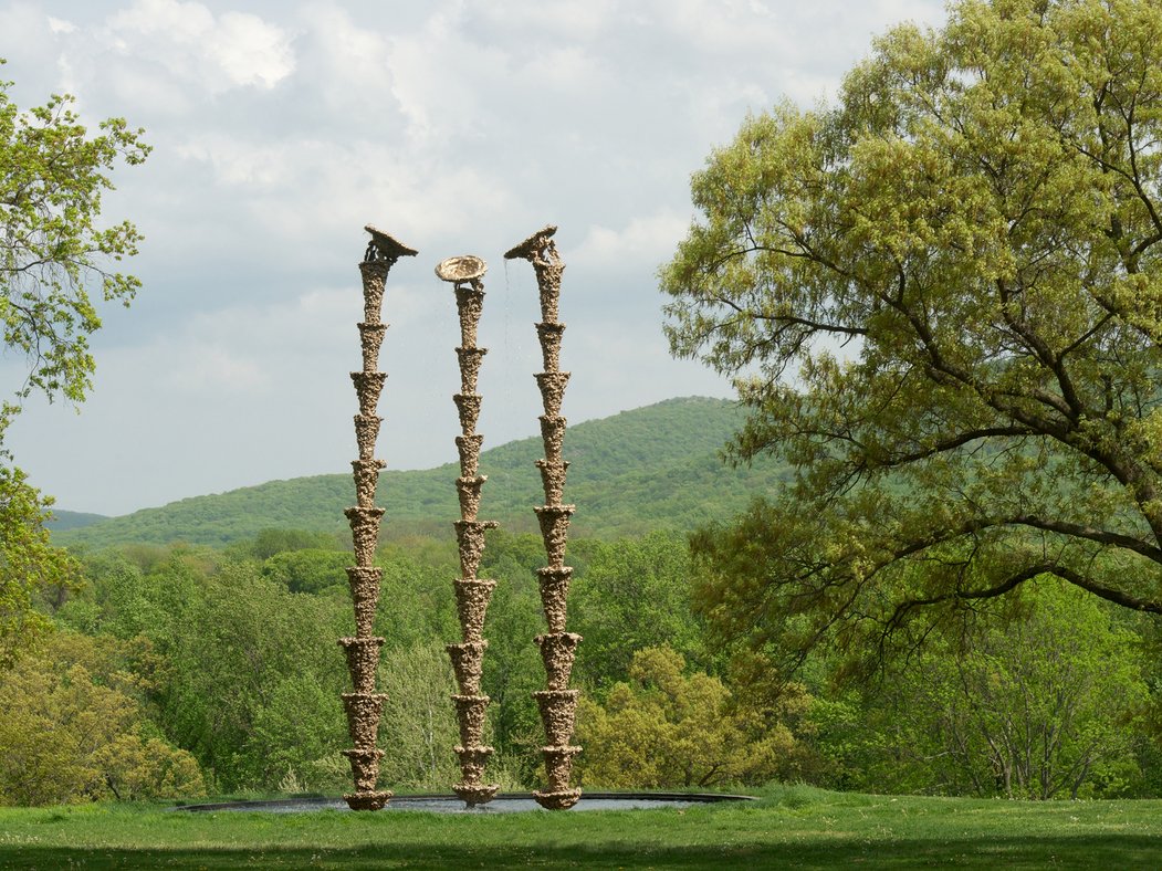 This image may contain Architecture, Building, Plant, Tree, Column, Pillar, Symbol, Emblem, Outdoors, and Grass