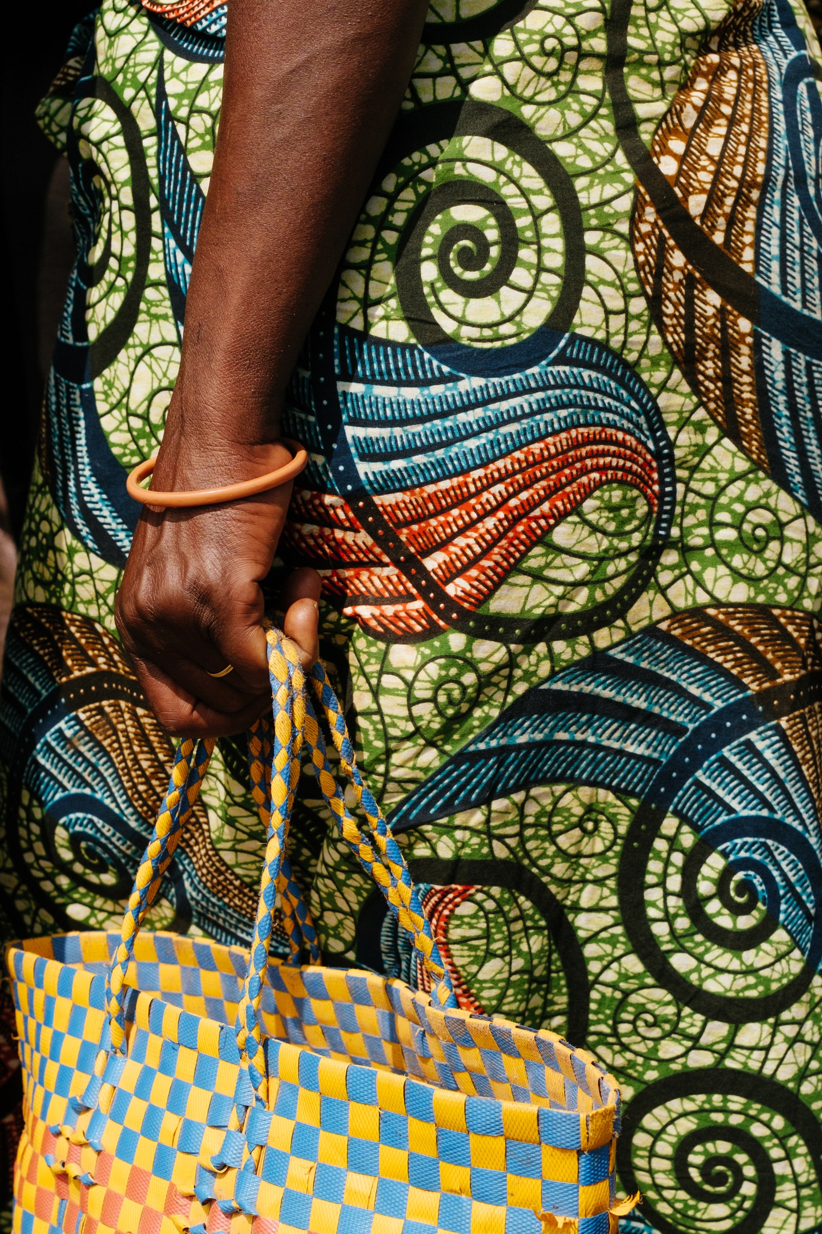 A woman waits at a market near Nkombo Island