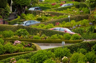 winding street with cars driving down