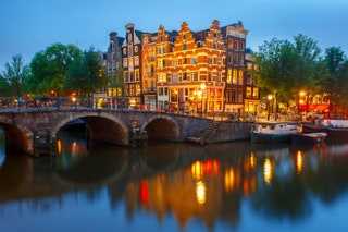 building reflected in water at dusk