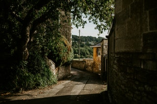 Image may contain City Road Street Urban Alley Outdoors Nature Path Countryside Plant Vegetation and Scenery