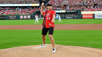 Neighbours throws out first pitch