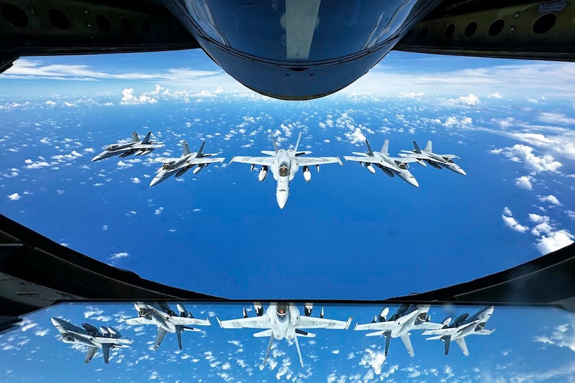 Five aircraft fly in formation.