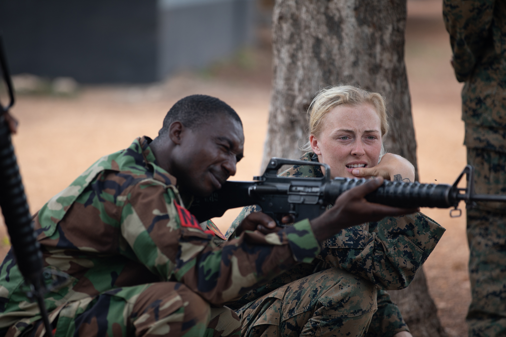 A sailor runs with a group of Kenyan service members