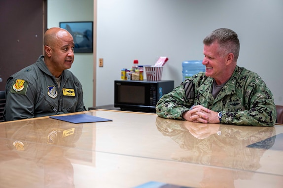 Brig. Gen. Phillip L. Mallory, (left) commander of the 154th Wing, Hawai'i Air National Guard, and Adm. Samuel J. Paparo, commander of U.S. Indo-Pacific Command, speak to one another during Paparo’s visit to the 154th Force Support Squadron on Joint Base Pearl Harbor-Hickam, Hawai'i, on Aug. 12, 2024.