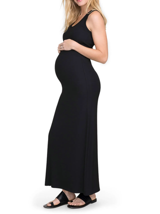 Woman wearing black tank dress on a white background