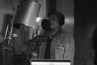 Radha Blank rapping in a recording studio