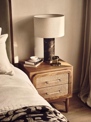 Image may contain Lamp Table Lamp Book Publication Bed and Furniture