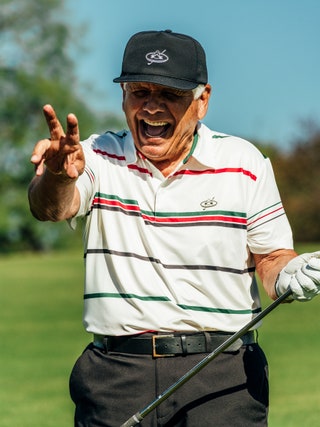 Image may contain Lee Trevino Clothing Glove Head Person Face Adult Accessories Belt Hat and Happy