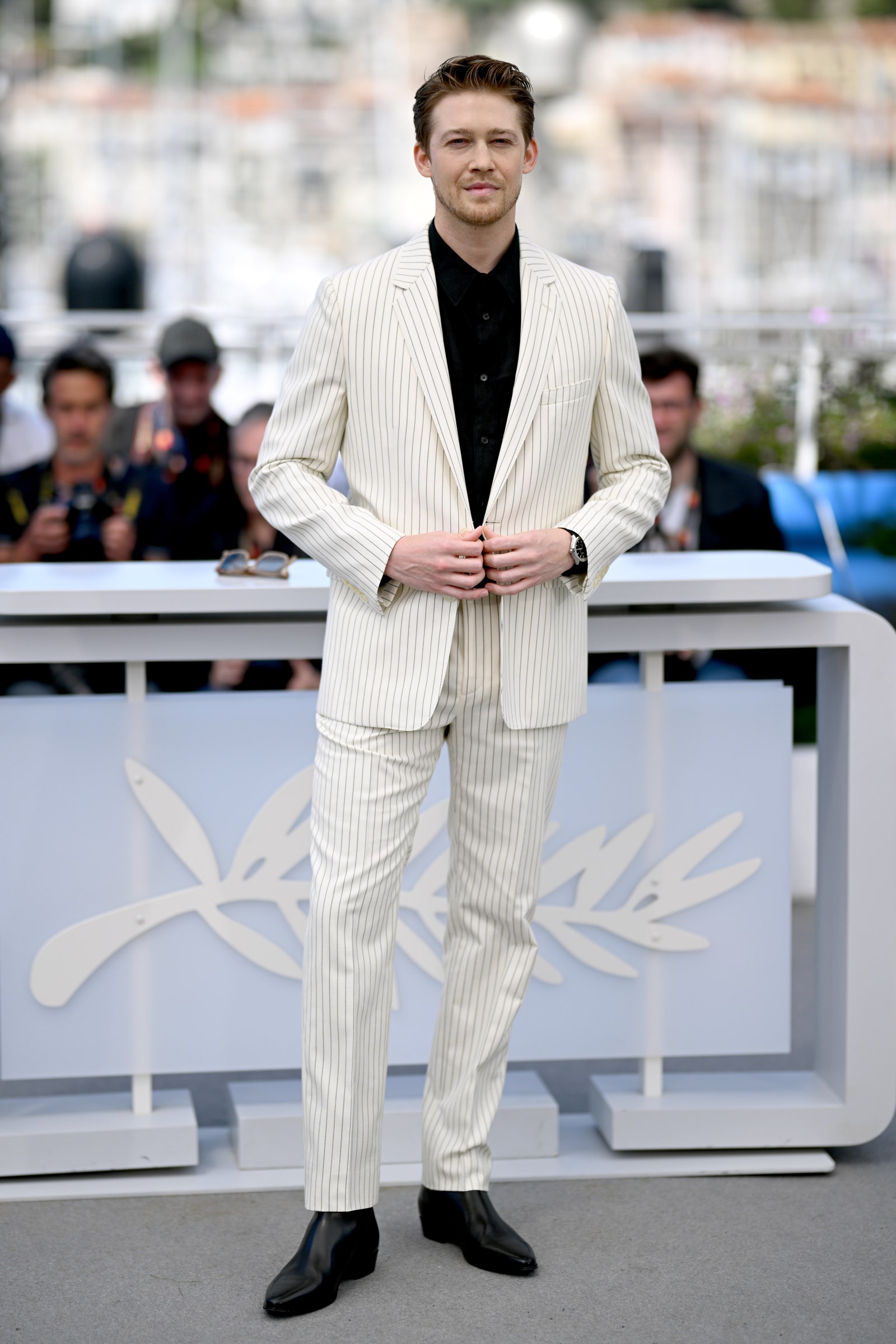 Image may contain Joe Alwyn Clothing Formal Wear Suit Person Standing Adult Accessories Glasses Hat and Coat