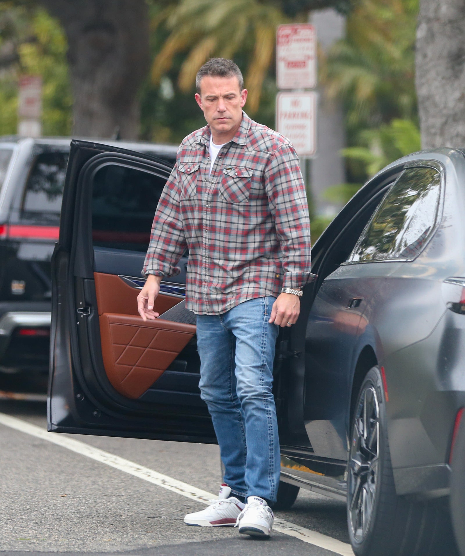 Image may contain Ben Affleck Clothing Pants Jeans Footwear Shoe Adult Person Car Transportation and Vehicle