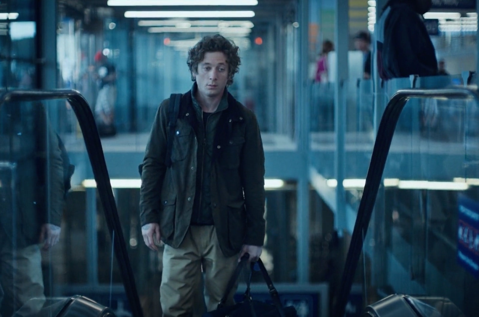 Image may contain Jeremy Allen White Adult Person Clothing Coat Accessories Bag Handbag Glove Jacket and Baggage