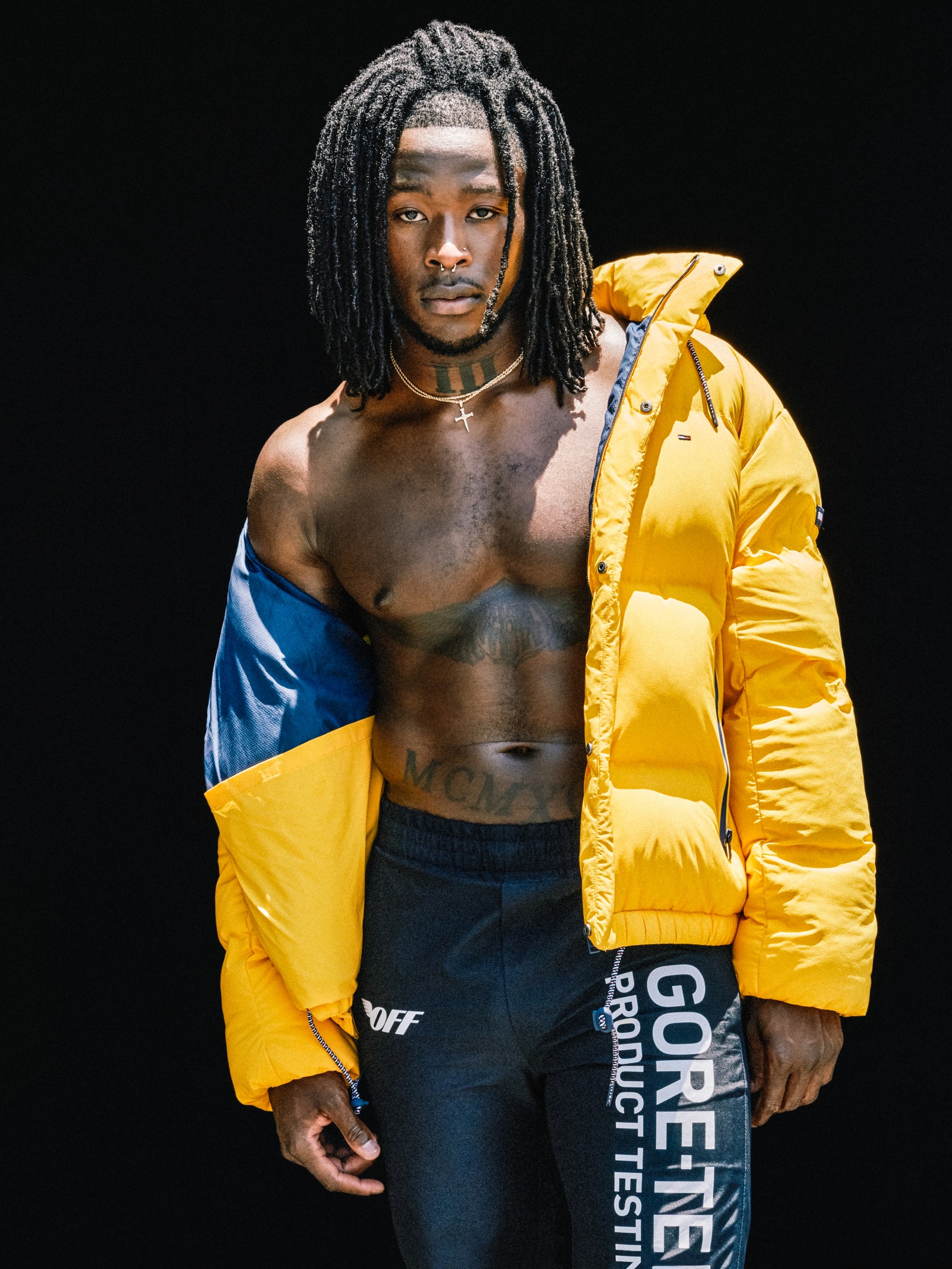 This image may contain Clothing Apparel Coat Raincoat Human Person and Alvin Kamara