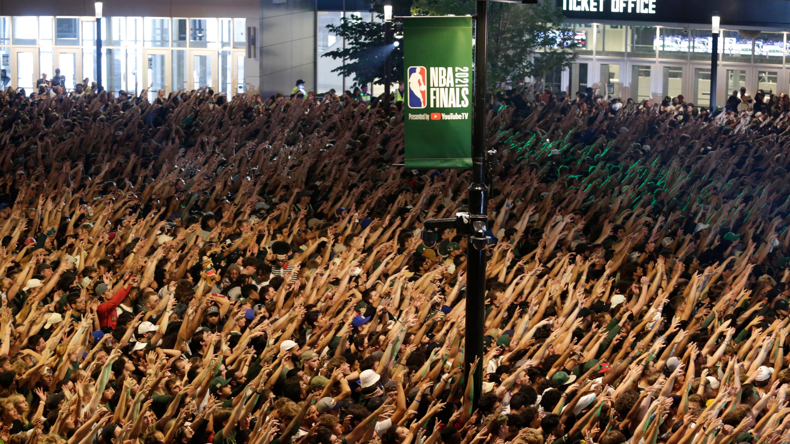 Bucks fans celebrate outside Fiserv Forum .