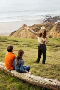 Hispanic park ranger talking to children