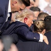Republican presidential candidate former President Donald Trump is helped off the stage at a campaign event in Butler, Pa., on Saturday, July 13, 2024. 