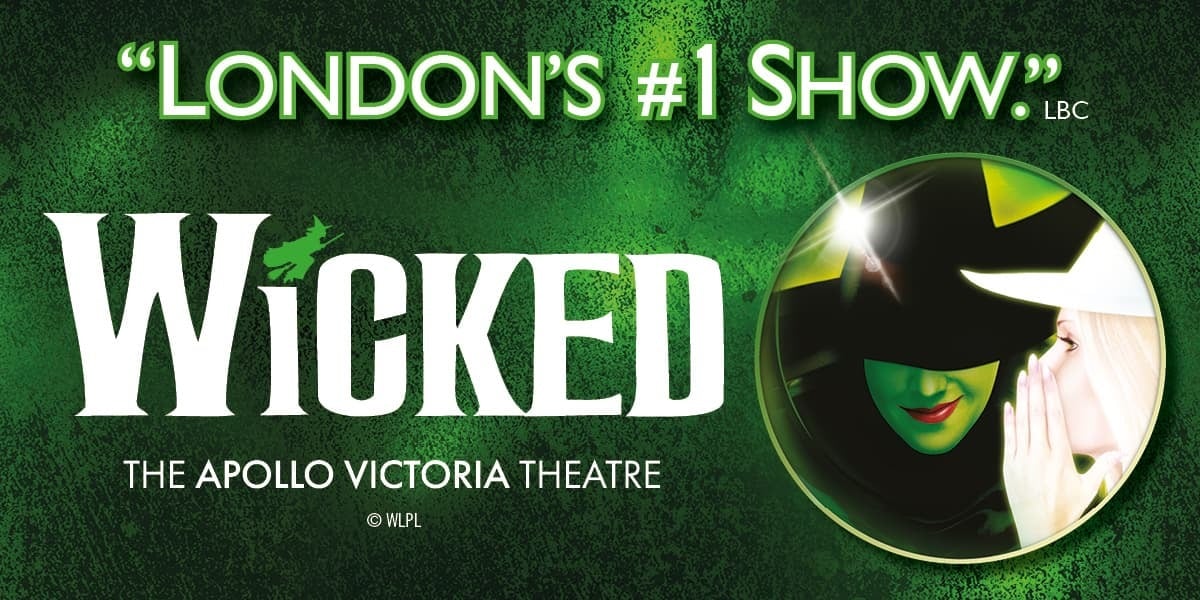 Green background. Text: [top]"London's #1 Show." Wicked (the dot on the 'i' is a silhouette of a witch on a broom) [bottom] The Apollo Victoria Theatre Image within a circle frame Green witch in a black pointy hat and robe faces forward, side profile of a witch in contrasting white whispers to her.